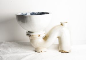 a white toilet cistern and pipe