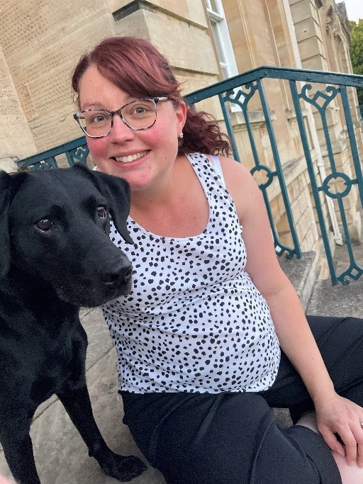 Pregnant lady sat on the front steps to Cusworth Hall with black dog.